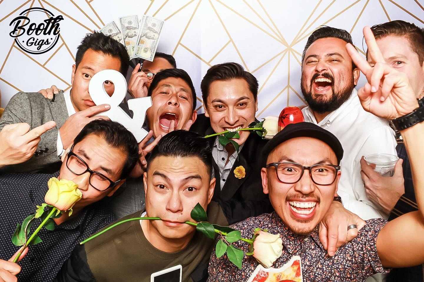 A group of friends with roses and signs on the white geometric backdrop