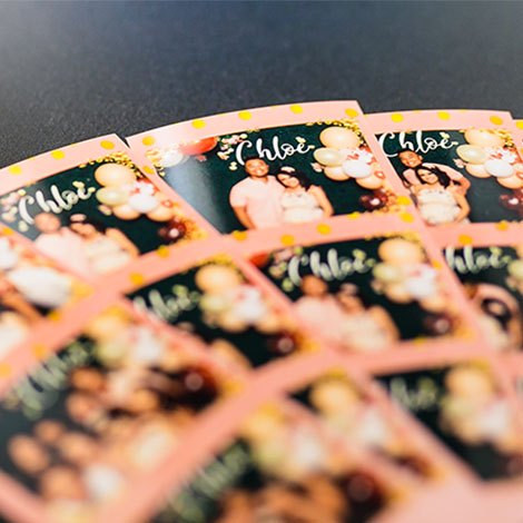 Fanned 2×6 photo strips from Chloe's baby shower with the Booth Gigs logo
